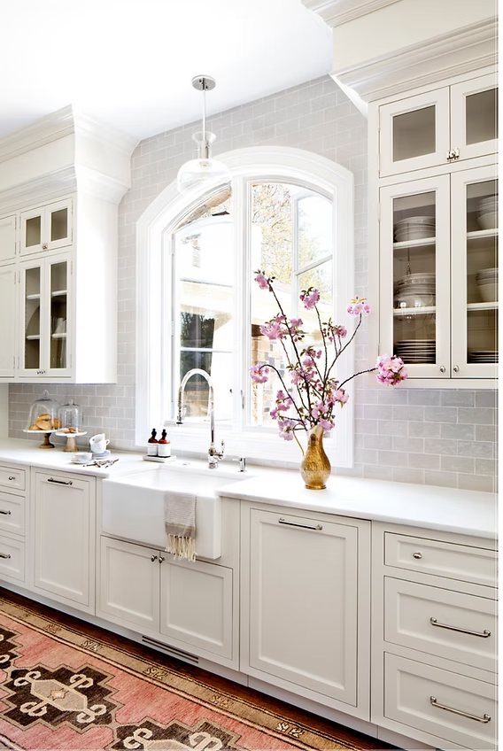 Shaker kitchen cabinets in a bright kitchen with a farmhouse sink